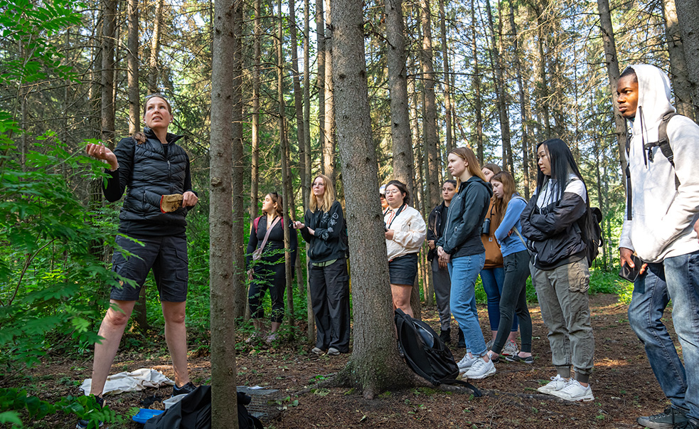 instructor with students outdoors