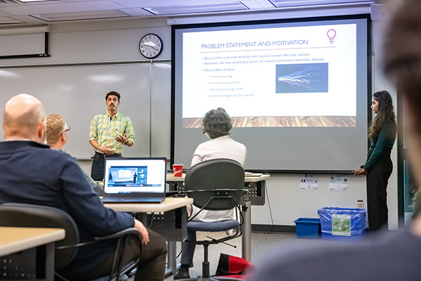 student presenting research findings in front of a class