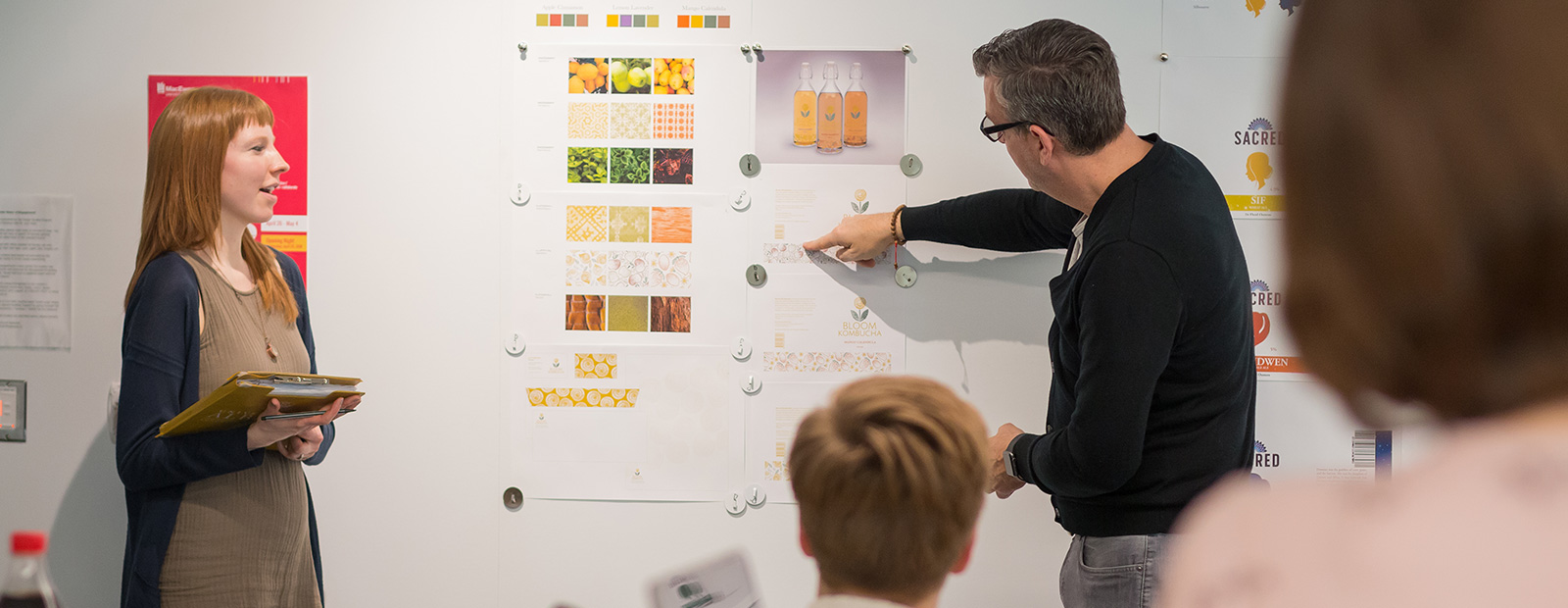 instructor pointing to whiteboard with students