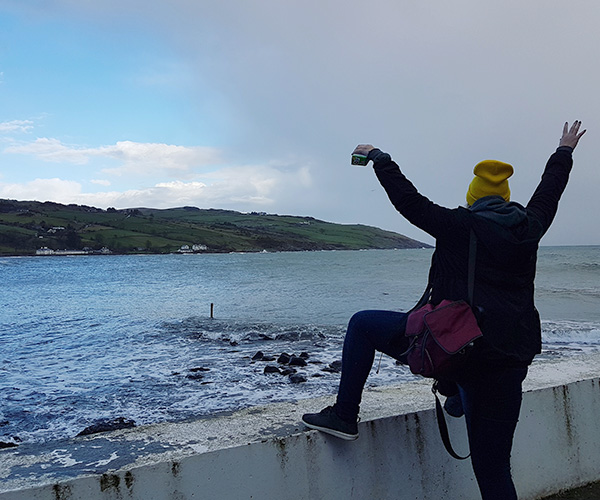Erika Altrogge stands at a seawall in Ballygally in Northern Ireland