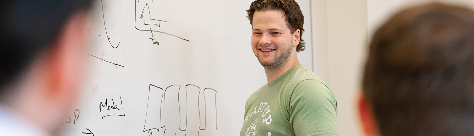 student in front of white board