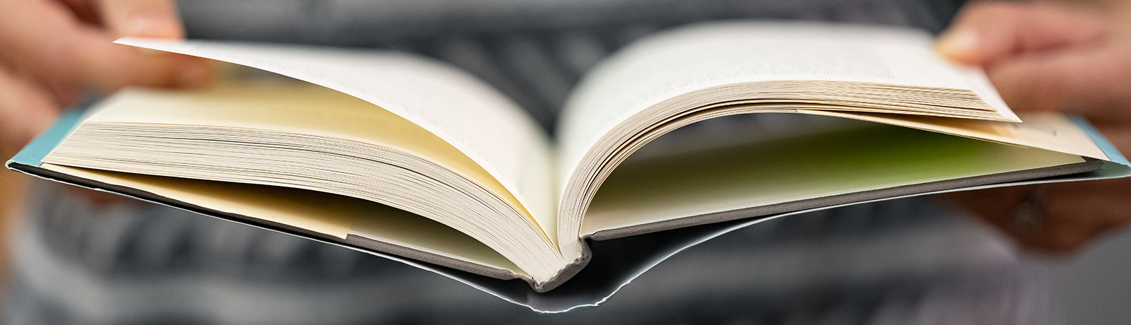 holding open book