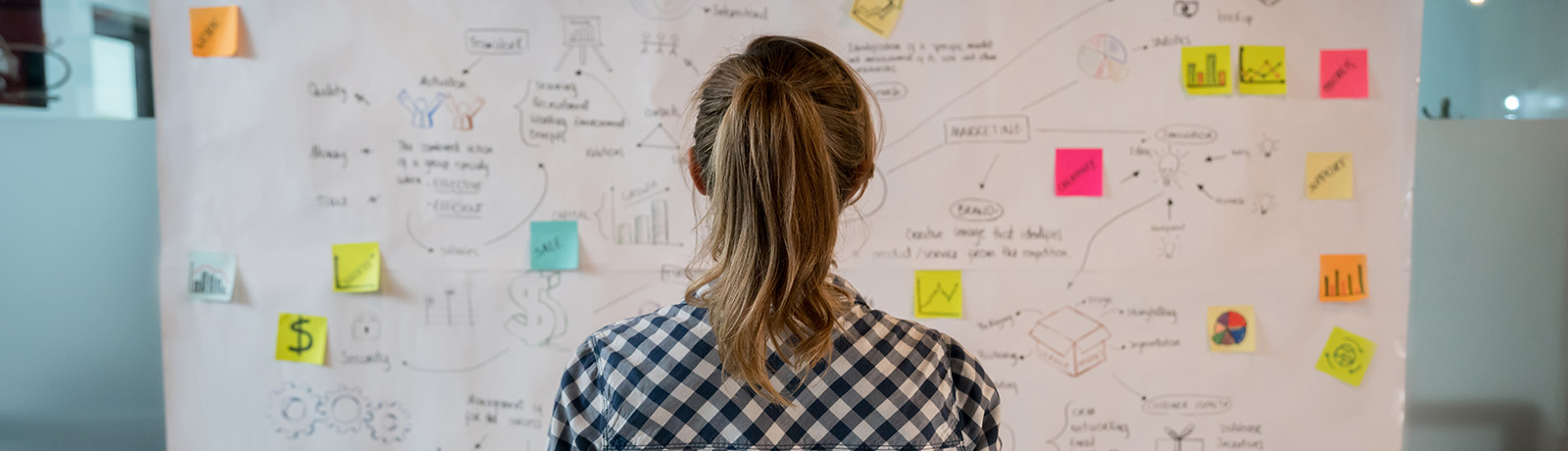woman looking at white board