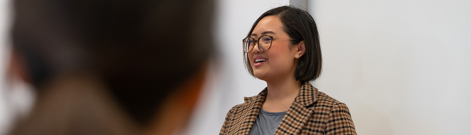 female student presenting in front of class