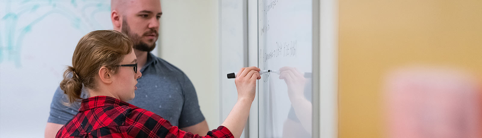 math students working on whiteboard