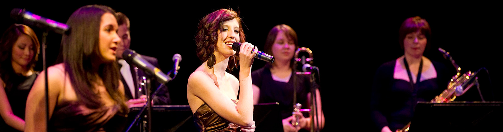 Student singing on stage at concert