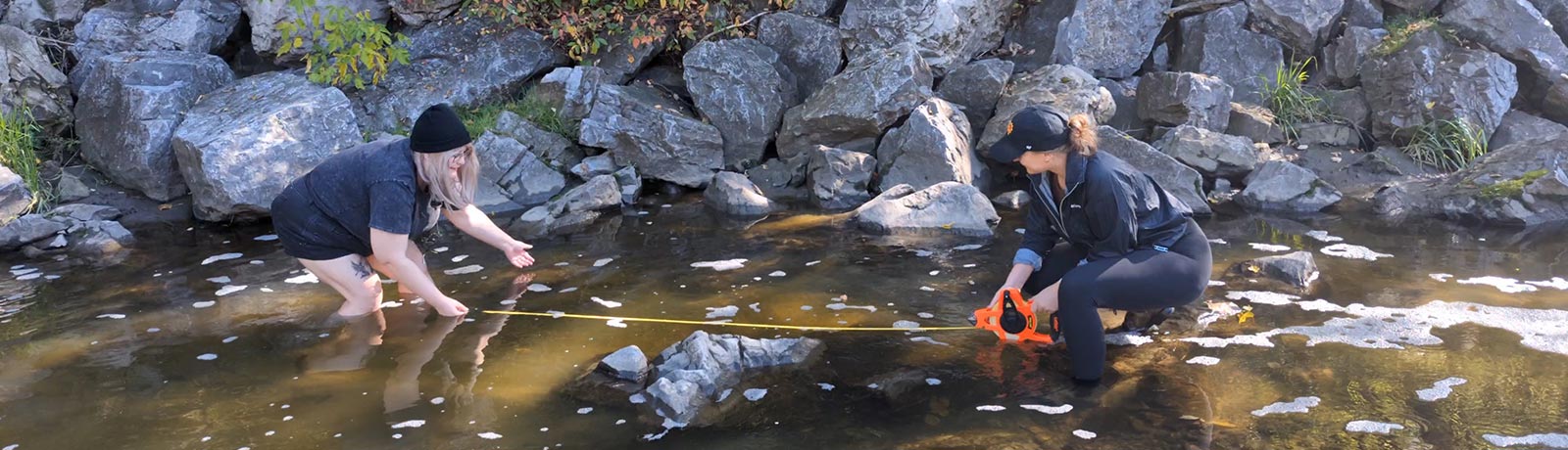 students taking measurements in stream