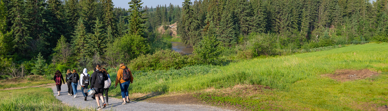 students walking in river valley