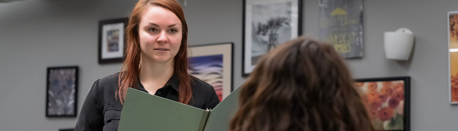 student in work place talking to coworker