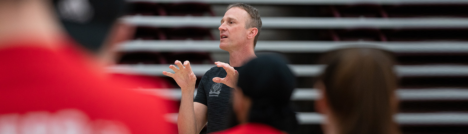 Recruiter speaking to students in gym