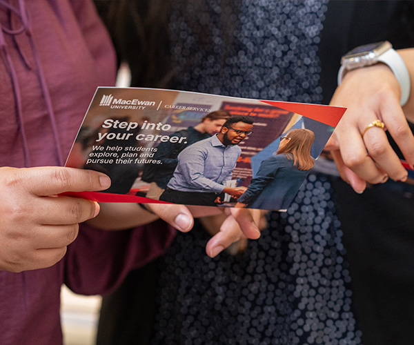 close up of hands holding a printed brochure