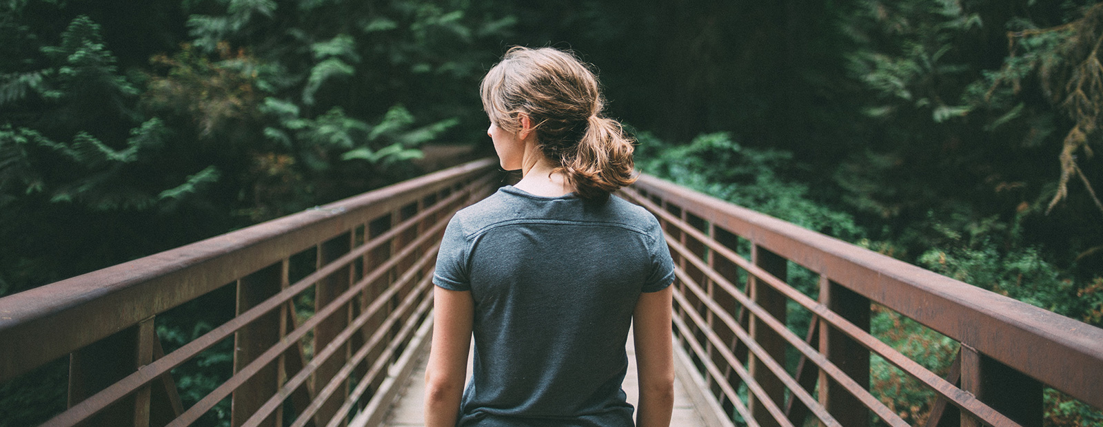 woman standing on bridge