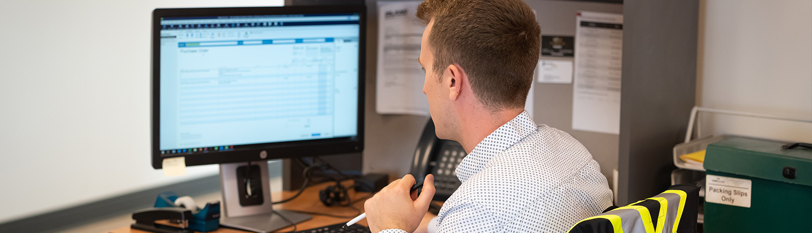 back of man at desk