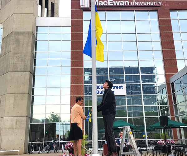 raising ukrainian flag outside MacEwan