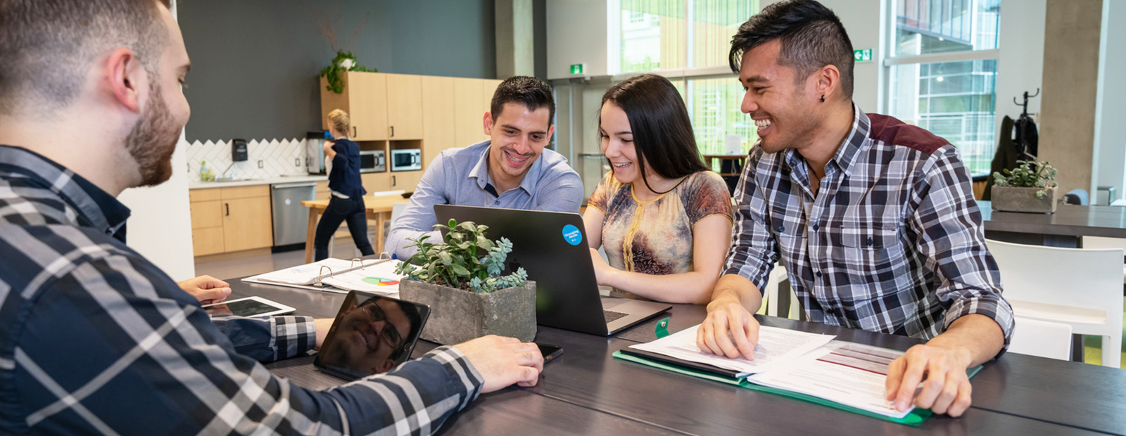 students sitting around laptop