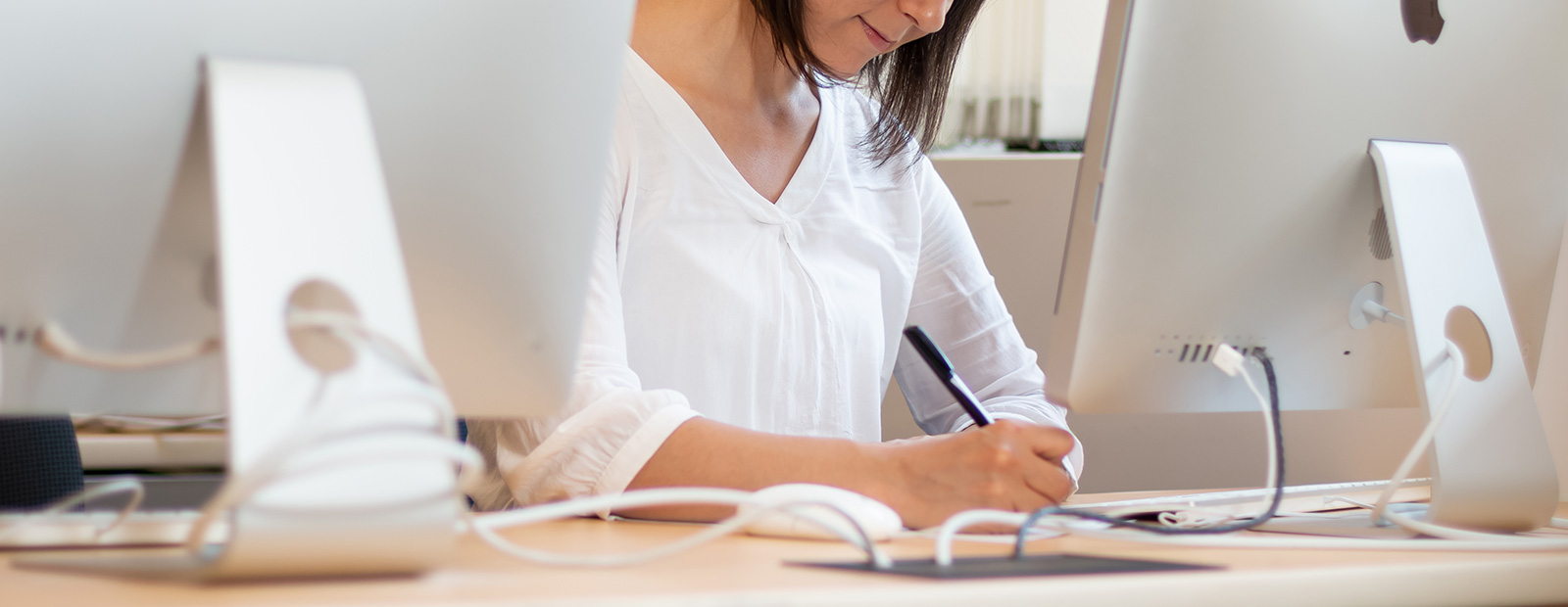 girl sitting at computer while writing