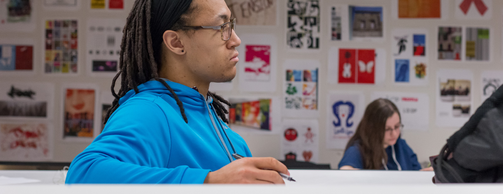 student at desk in design class
