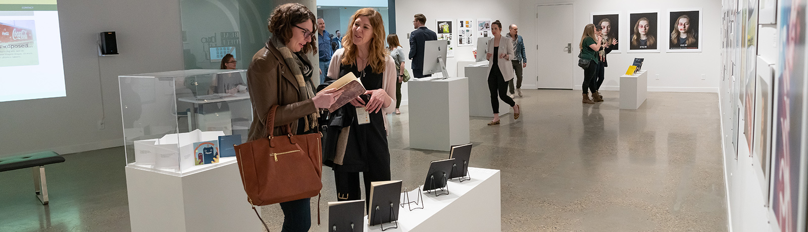 art gallery filled with people looking at work