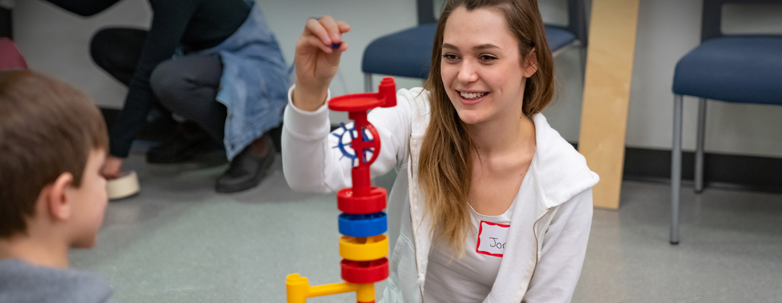 student playing with child