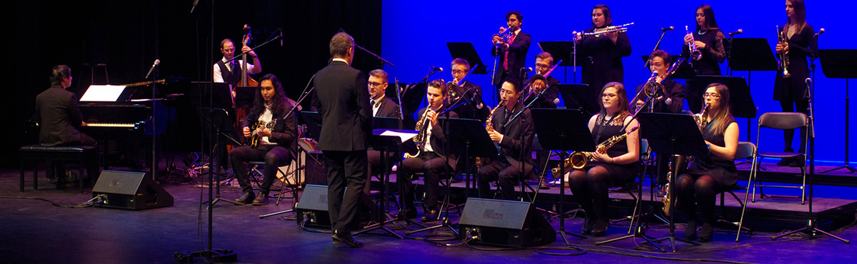 group of students playing instruments on stage