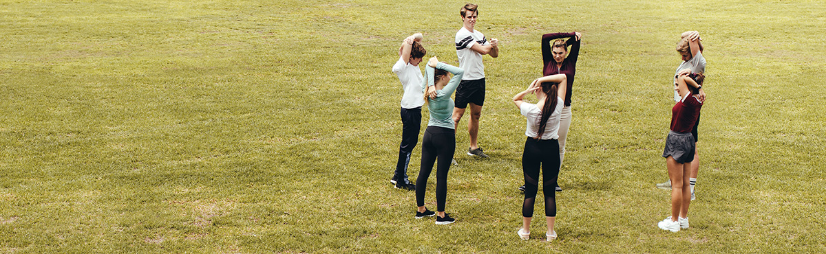 students stretching outside