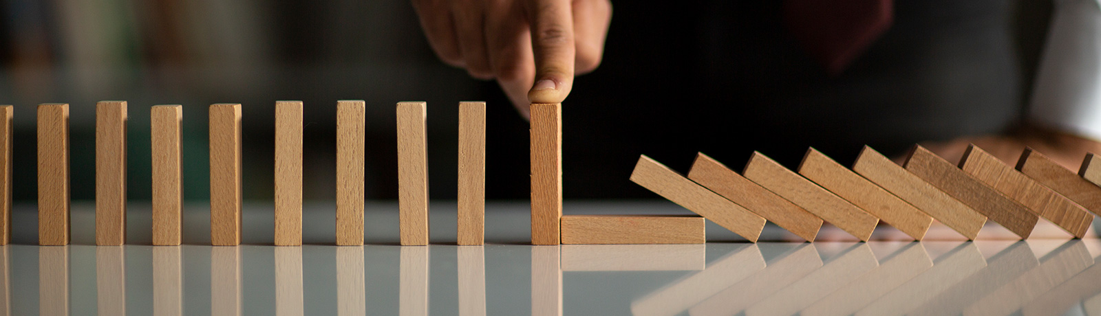 man Stopping Domino Effect