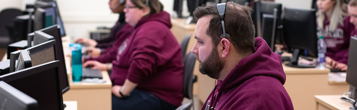 students in class with headsets