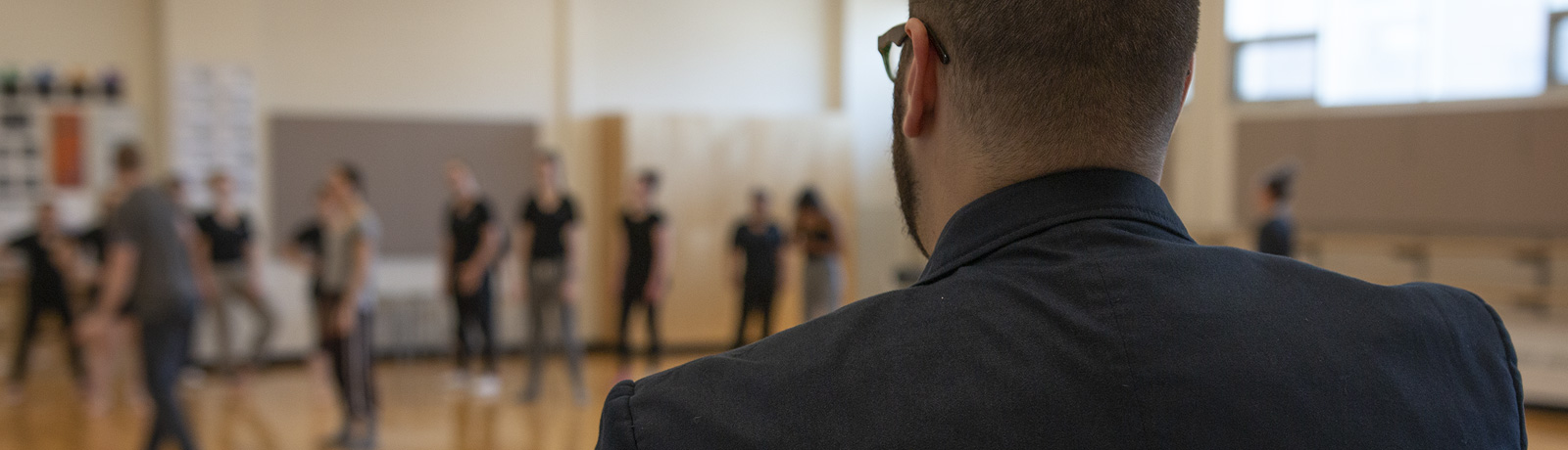 man standing watching practice