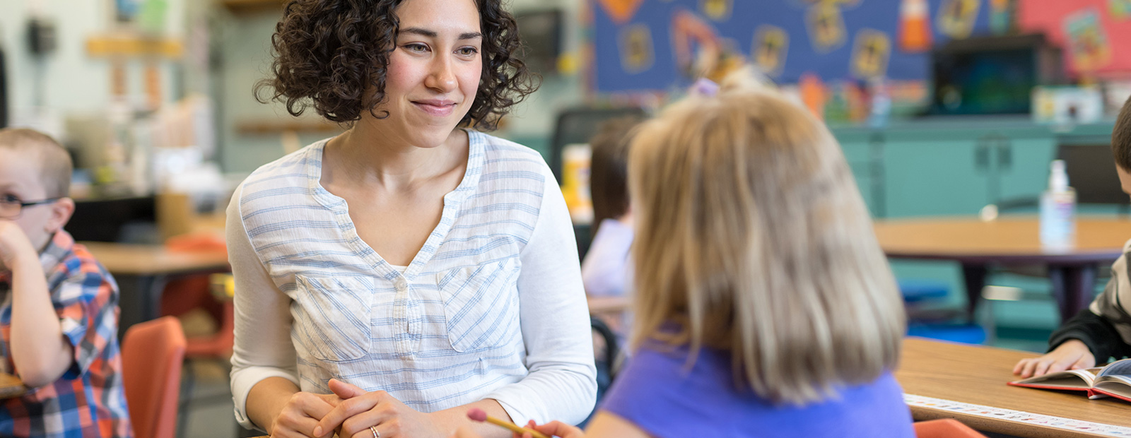 young teacher with elementary school student