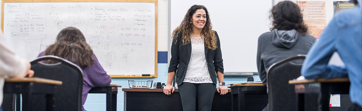 student standing in front of class