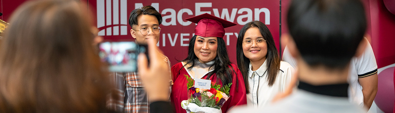 grad student smiling while getting photos taken