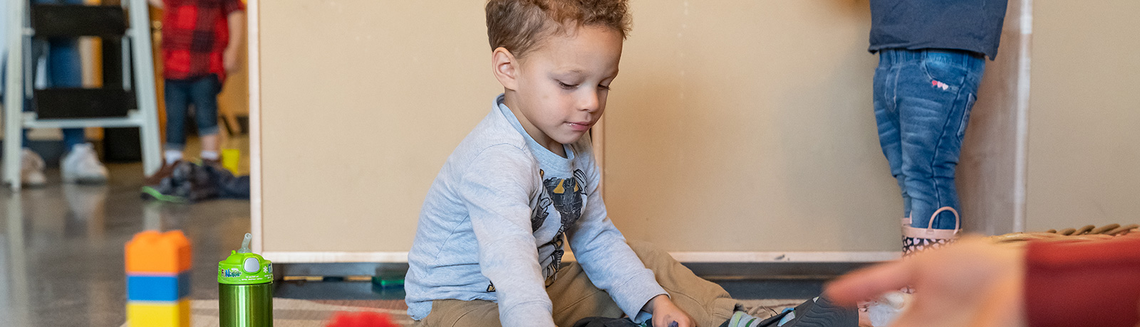 little boy playing with blocks