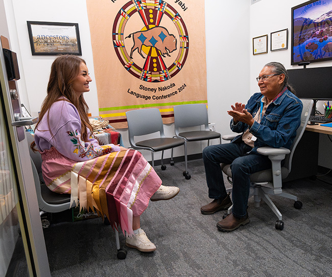 knowledge keeper speaking to young woman