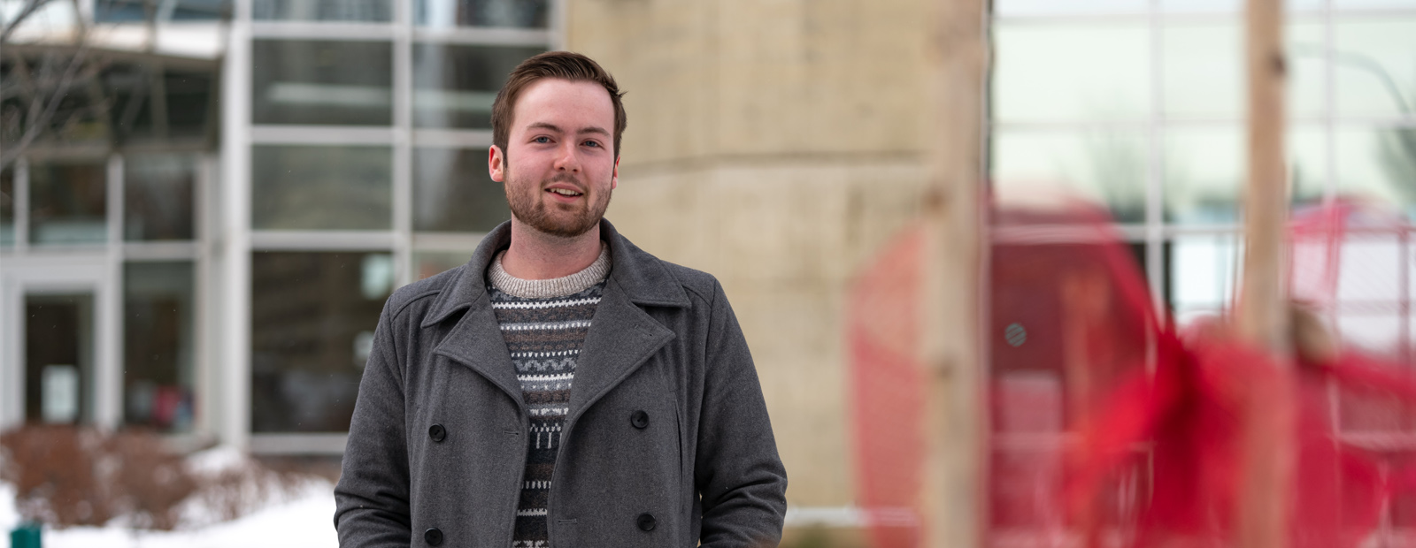 Iain Smith standing outside clock tower entrance on cold day
