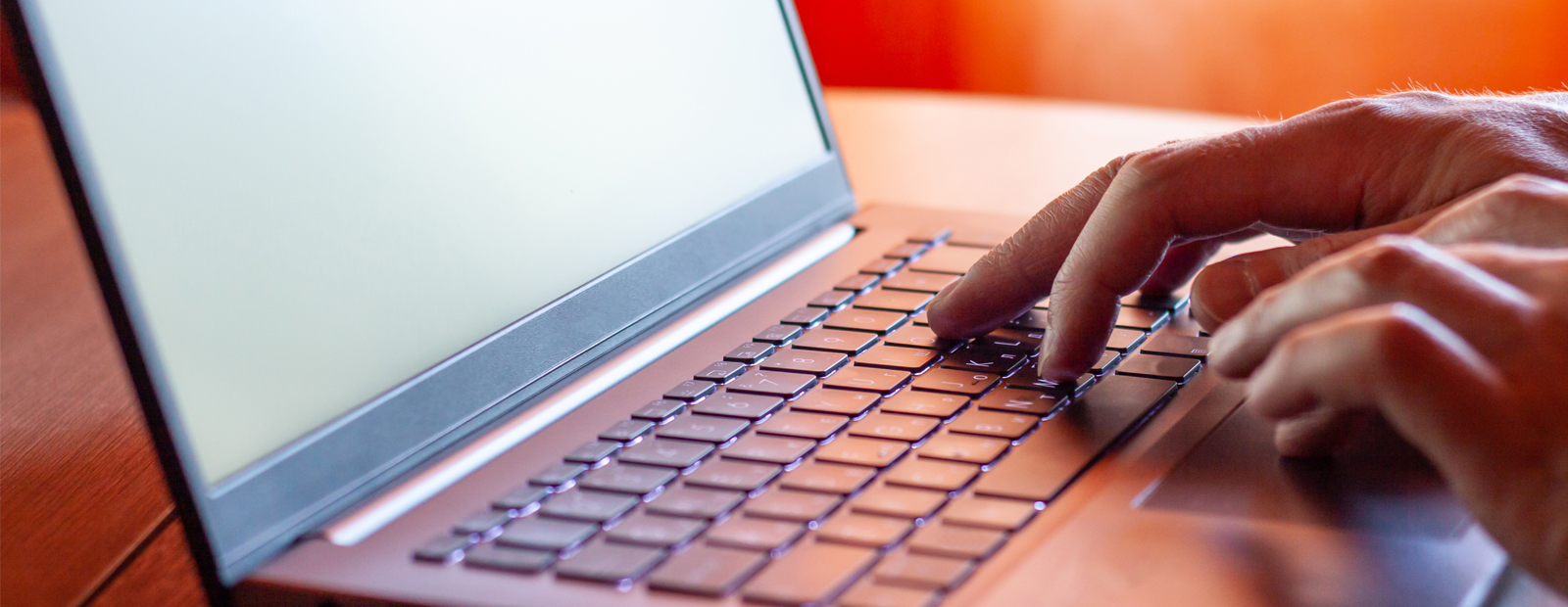 Stock image of hands typing on a laptop