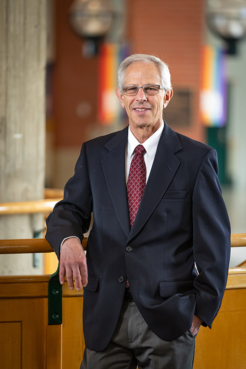  Dr. Richard Perlow stands on the spiral staircase in Building 6.