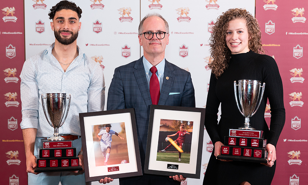 Athletes Ricky Yassin and Samantha Gouveia pose with trophies.