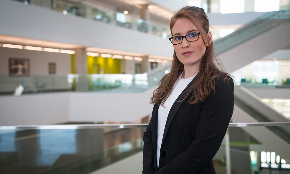 Dr. Emily Milne stands in the Allard Hall building on MacEwan University's City Centre Campus.