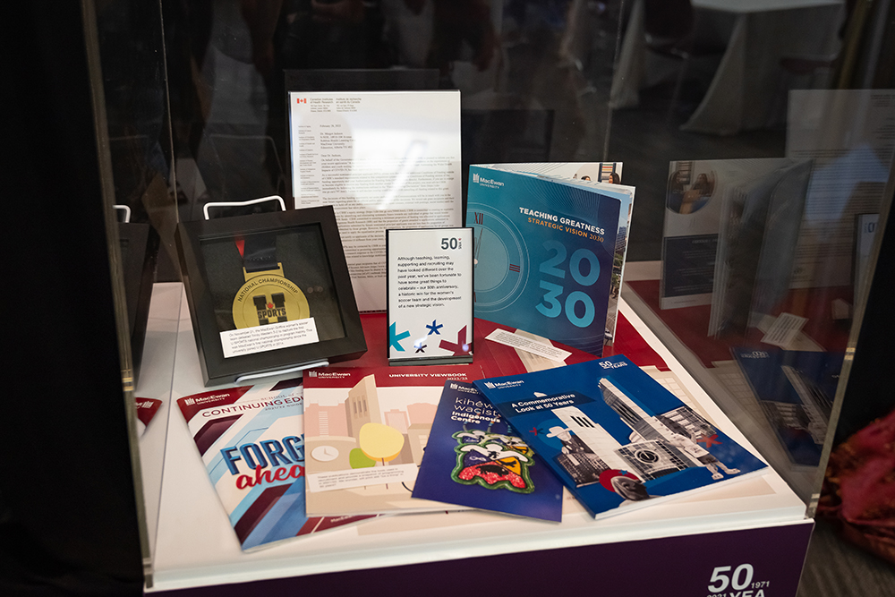 Time capsule items in a glass display box.