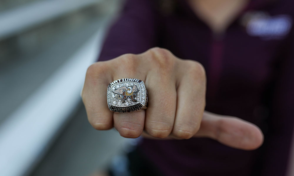 A close-up of a hand wearing the championship ring.