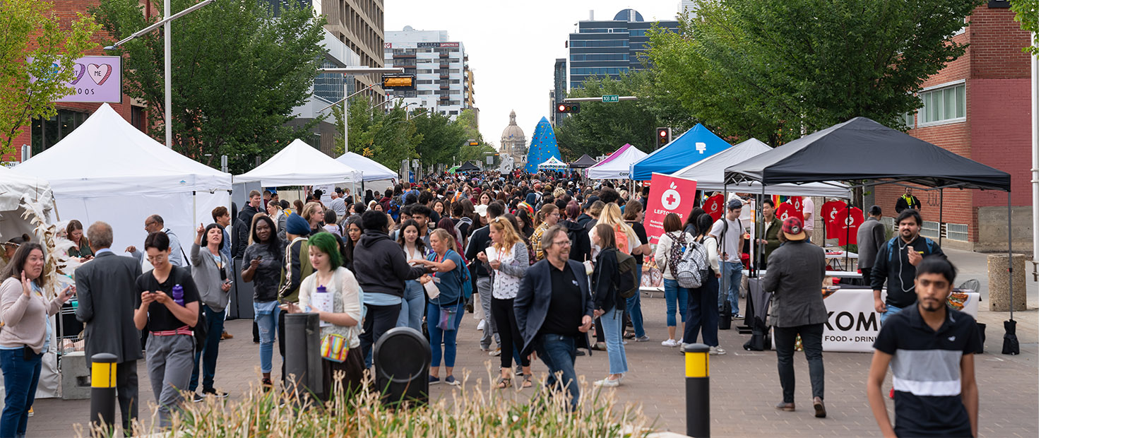 A crowd of people walking, eating and enjoying the festivities at the Downtown Campus Block Party