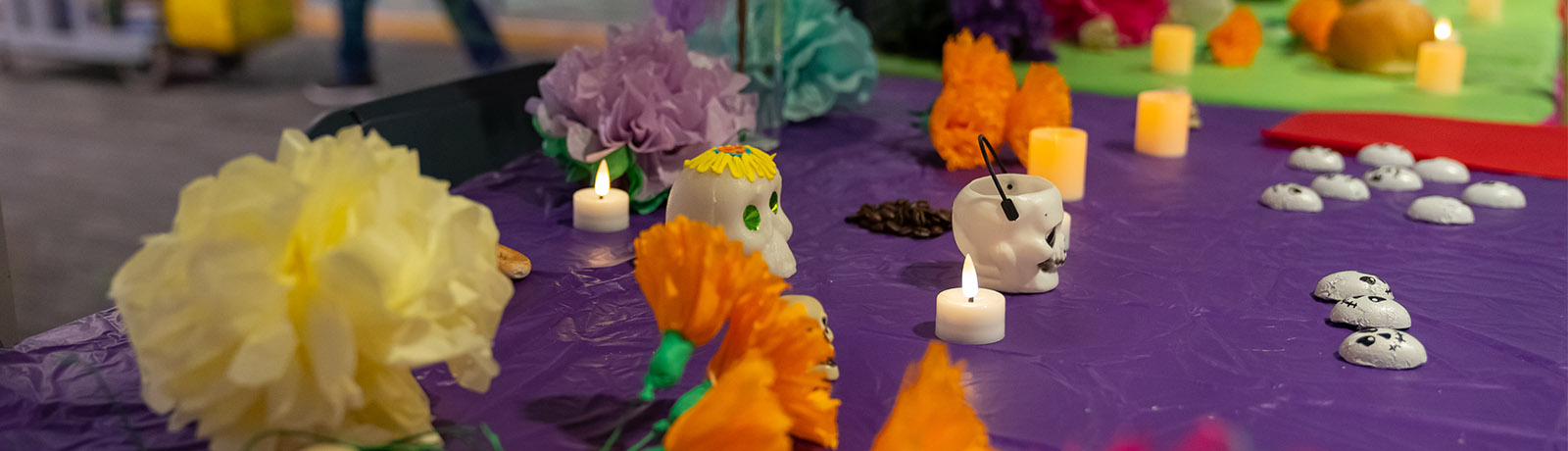 Display of colourful flowers and skulls for Day of the Dead