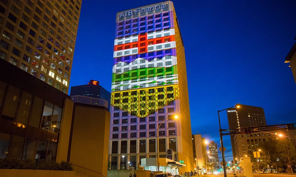 Image of the ATB tower in downtown Edmonton, lit up at night.