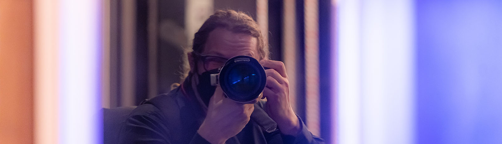 Steve Stefaniuk takes a photo of himself in the glass of Allard Hall