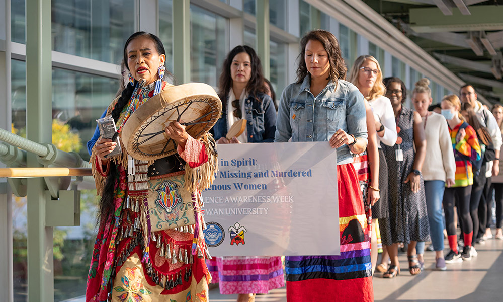 Cynthia Jim leads a march across campus on the National Day of Remembrance for Missing and Murdered Indigenous Women