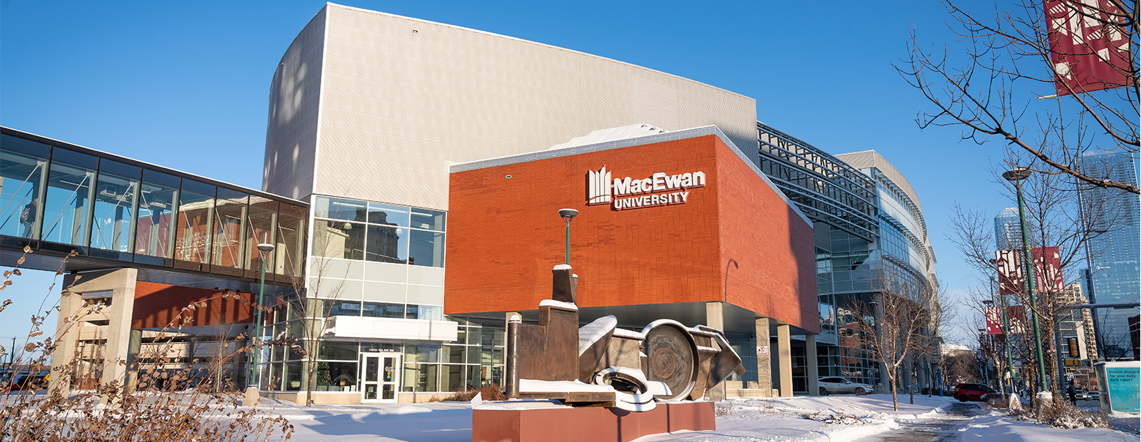 A shot of a sculpture outside of Building 9 on campus during the winter