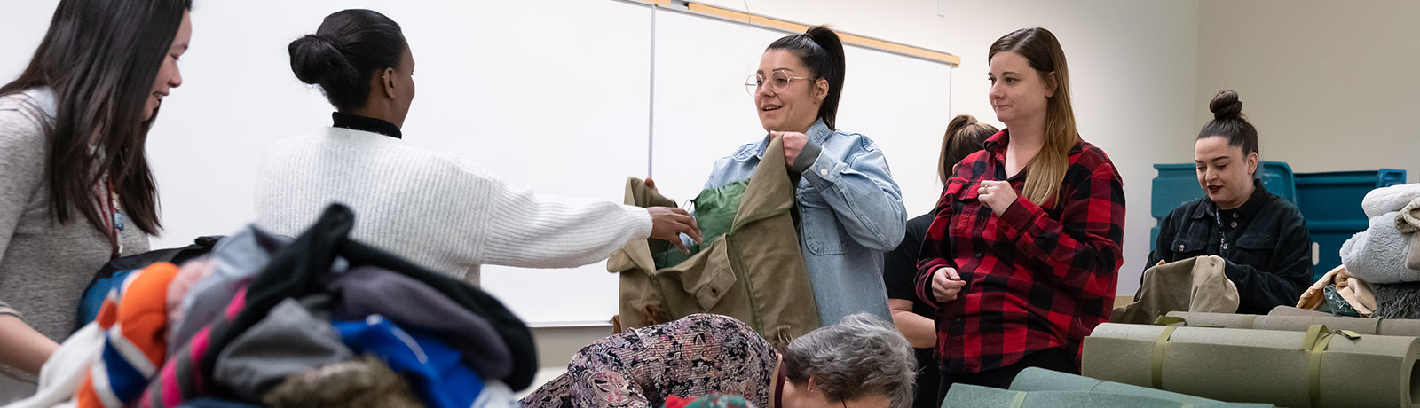 Volunteers fill backpacks in a classroom in the Robbins Health Learning Centre