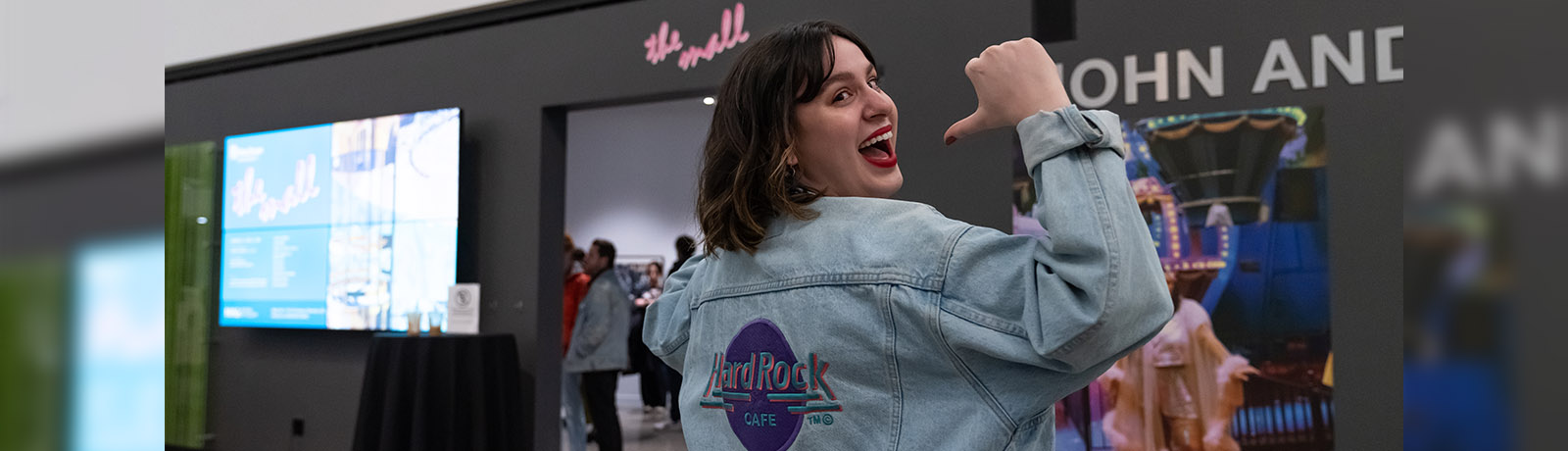 Hannah Quimper-Seiderski wears a light denim jacket with a Hard Rock Cafe Edmonton logo on the back