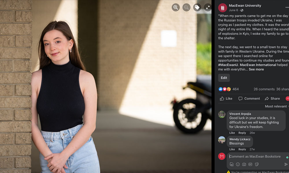 Kateryna Kuzmuk leans against a brick wall on campus