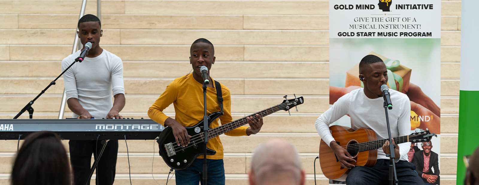 The Melisizwe Brothers perform music in front of a crowd at City Hall